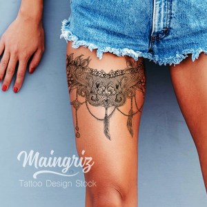 Lace garter tattoo with feather for woman created by Maingriz.com